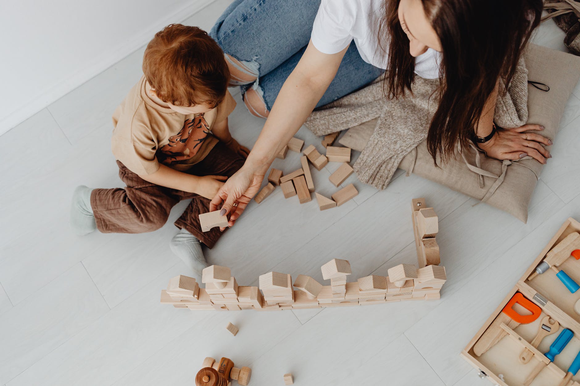 woman playing with toy blocks with son