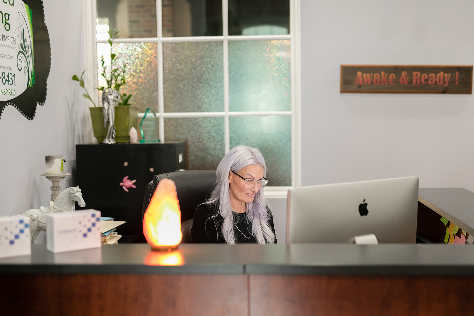 Dawna Weiss sitting at desk in office - When the Mold Hits Close to Home