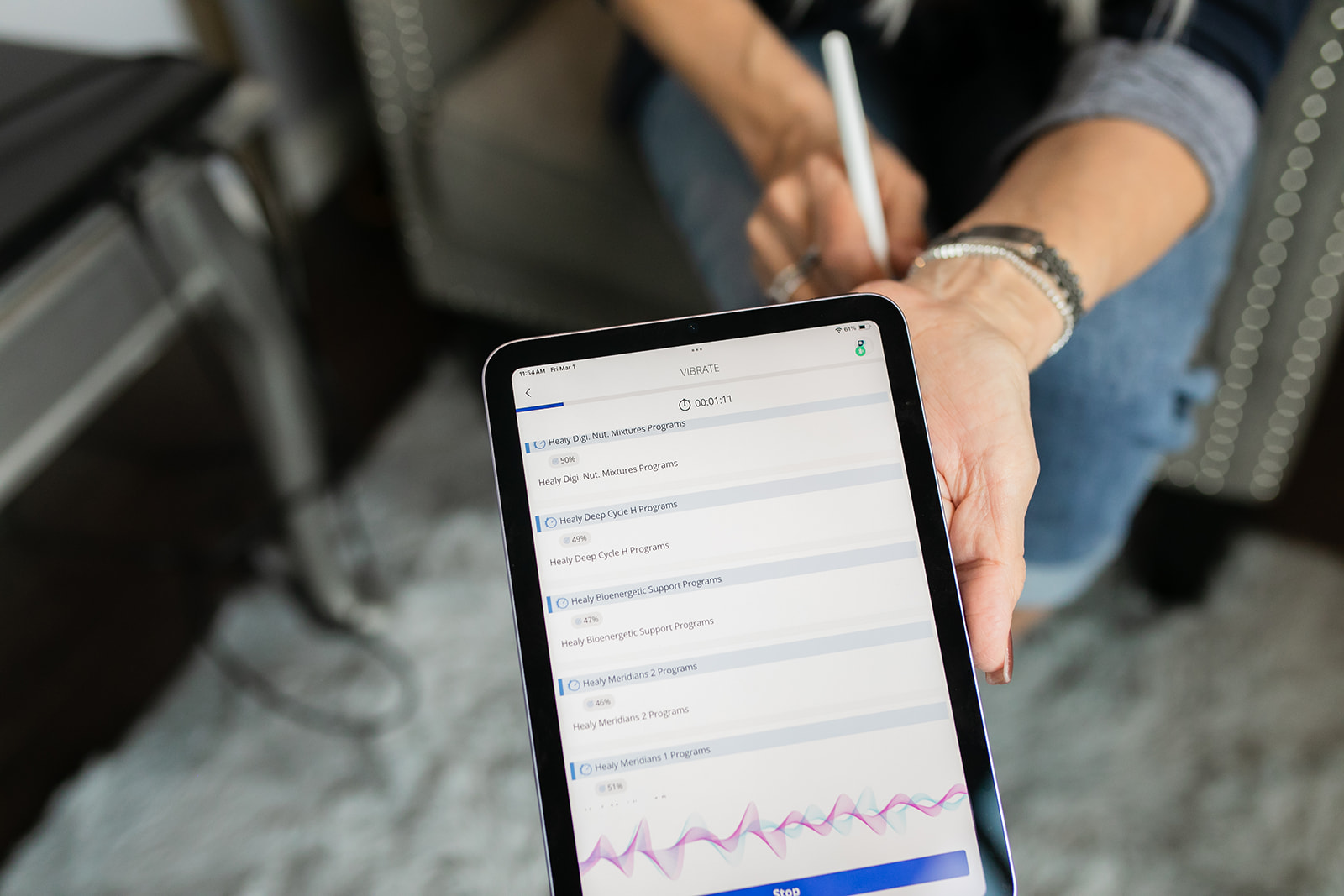 Dawna holding iPad while running Healy scan - healing as an alchemical process